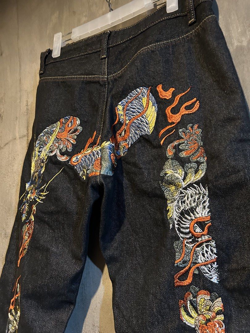 Evisu embroidered dragon design (Category: Jeans) located in Manila. Submitted by jayson221 (Listing ID 1467996733, Image 2). Description: Dimes W:31 L:39 Excellent condition No issue 10/10 colo rate - Style: Straight fit dark wash denim jeans - Design: Heavy, vibrant embroidery with dragon and flame motifs - Colors: Blue, orange, white, and yellow threads on solid indigo - Details: Standard waistband and belt loops - Condition: Unique statement 
