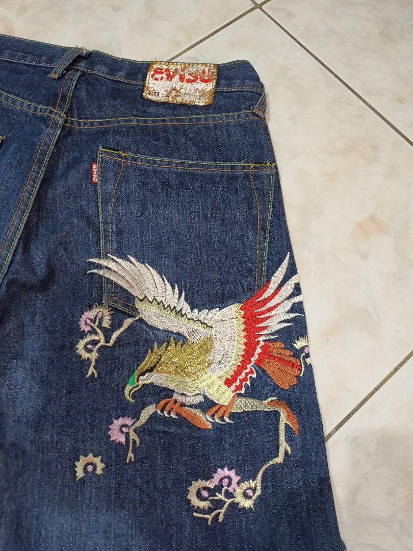Evisu Embroidered Eagle Denim Jeans Size 32 (Category: Jeans) located in Caloocan City. Submitted by cleverwind_1e53ab (Listing ID 1467871780, Image 2). Description: - Brand: Evisu - Size: Tagged 32 - Color: Dark blue wash - Material: 100% heavyweight cotton - Design: Detailed eagle and flower embroidery on the back leg - Details: Classic contrast stitching, clean interior labels, and intact back patch - Condition: Excellent pre-loved condition -