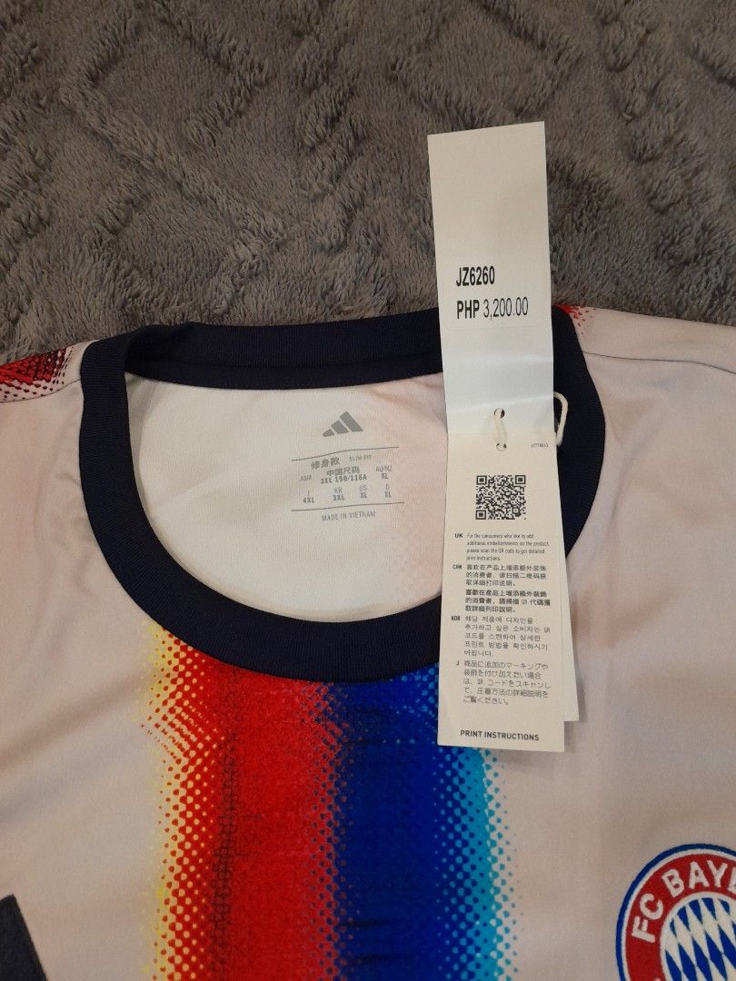 FC Bayern München Adidas Jersey (Category: Activewear) located in Las Pinas. Submitted by maljun1972 (Listing ID 1467919019, Image 2). Description: FC Bayern München home jersey from Adidas. Striking red, blue, and white graphic pattern across the front. Short sleeves with dark blue crew neck collar. Original tags attached, retail price PHP 3,200. Asian size 3XL, slim fit style. Measurements show length around 29 inches and chest width around 23 