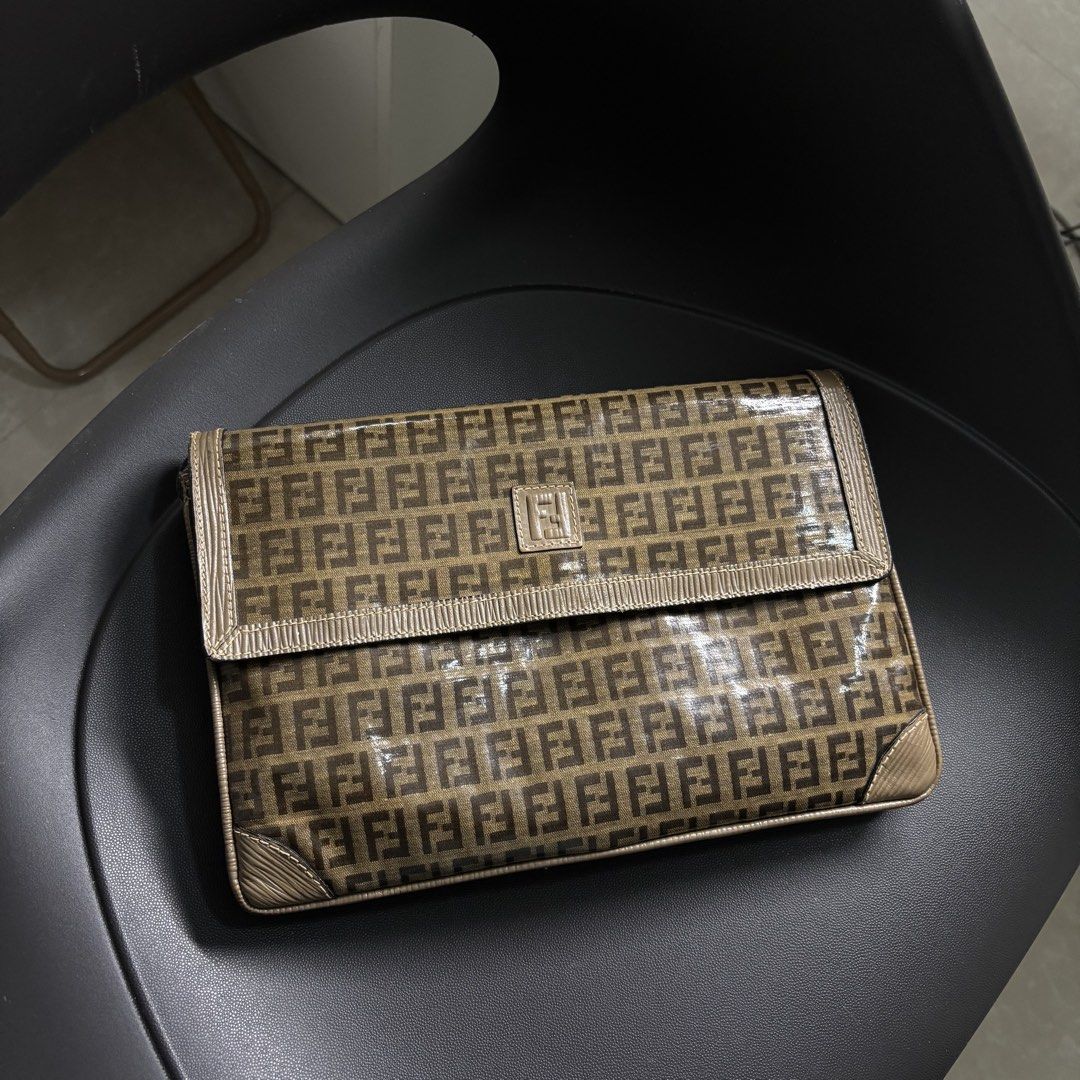 Fendi Monogram PVC Clutch Bag (Category: Luxury Bags & Wallets) located in Makati City. Submitted by dianedelro (Listing ID 1467937694, Image 2). Description: - Authentic vintage Fendi - Structured flap closure featuring taupe trim and a metal Fendi logo plaque - Adjustable leather strap for comfortable wear - Spacious brown fabric-lined interior with a secure zipped pocket - Includes the authentic gold Fendi S.A.S. stamp label - Timeless everyda