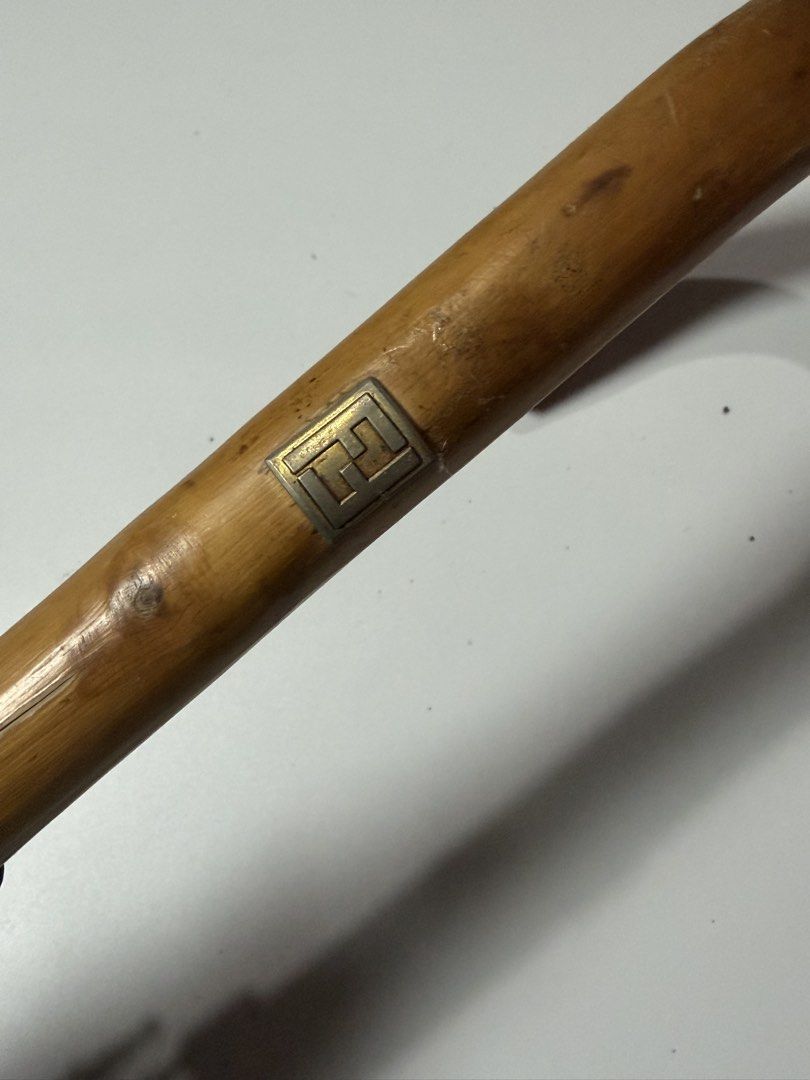 Fendi Monogram Umbrella (Category: Umbrellas) located in Manila. Submitted by swaaaaggy (Listing ID 1467860452, Image 3). Description: - Authentic Fendi monogram umbrella - Striking red fabric with gold FF logo border and details - Elegant curved wooden handle with engraved Fendi hardware - Branded snap button strap closure - Pre-loved condition (approx. 7/10) with minor signs of wear - Stylish designer accessory for rain or sun protection.