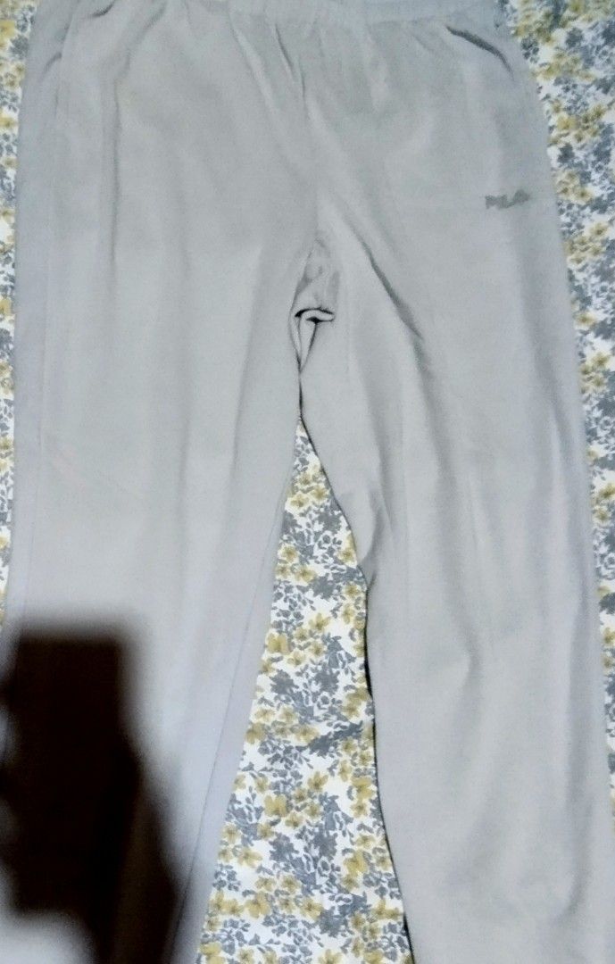 FILA Grey Sweatpants Joggers Size L (Category: Other Bottoms) located in Manila. Submitted by lene48 (Listing ID 1467963262, Image 2). Description: - Brand: Fila - Size: Large (L) - Color: Grey - Material: Soft cotton blend (Made in Vietnam) - Features: Elastic waistband with adjustable drawstring - Detail: Small dotted Fila logo on the left hip - Condition/Use: Great for lounging or running errands.