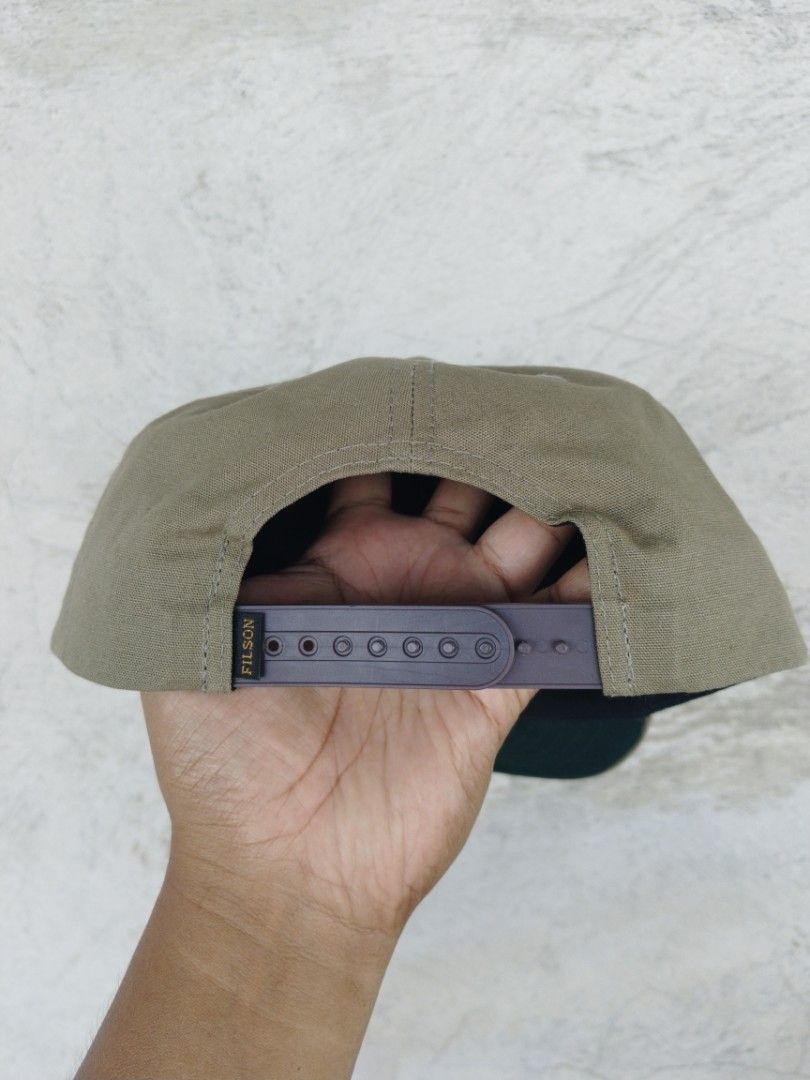 Filson snapback (Category: Caps & Hats) located in Legazpi City. Submitted by genobecollectives (Listing ID 1467899338, Image 2). Description: Filson snapback 1200 free ship - Color: Olive green with brown adjustable snapback - Design: Bear logo and 1897 text on front panel, green under brim - Material: 100% cotton shell, 100% polyester lining - Origin: Made in Bangladesh - Care: Spot clean only - Condition: Excellent / Brand New my kunting sulat