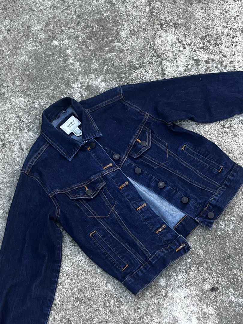 Forever 21 Dark Blue Denim Jacket (Category: Coats, Jackets and Outerwear) located in San Fernando. Submitted by angelhave_wings (Listing ID 1468058251, Image 3). Description: - Brand: Forever 21 - Style: Dark wash denim jacket - Size: Small - Details: Classic button-up front, chest pockets, and convenient side welt pockets - Accent: Stylish contrast orange stitching throughout - Condition: Excellent, well-maintained.