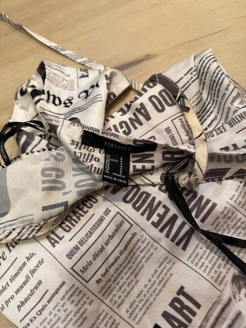 Forever 21 Newspaper Print Halter Top (Category: Sleeveless) located in Manila. Submitted by _____car0usell (Listing ID 1467959941, Image 3). Description: can be tied to ur size, adjustable.