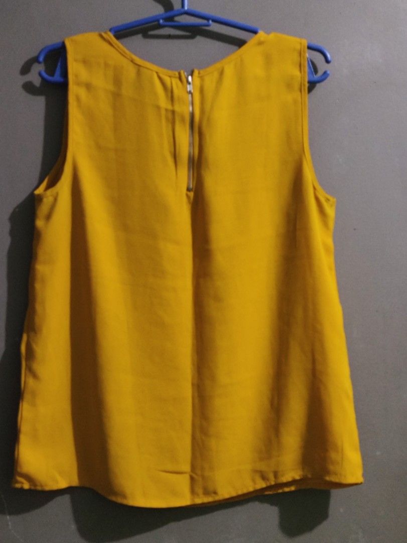 Forever 21 Yellow Sleeveless Blouse Size S (Category: Sleeveless) located in Manila. Submitted by rarelion_c637f7 (Listing ID 1467988541, Image 3). Description: - Brand: Forever 21 - Size: Small - Color: Mustard Yellow - Style: Sleeveless blouse with round neckline - Details: Sheer stripe panel on the chest and trendy exposed back zipper - Fabric: Lightweight and versatile, perfect to pair with skirts or pants.