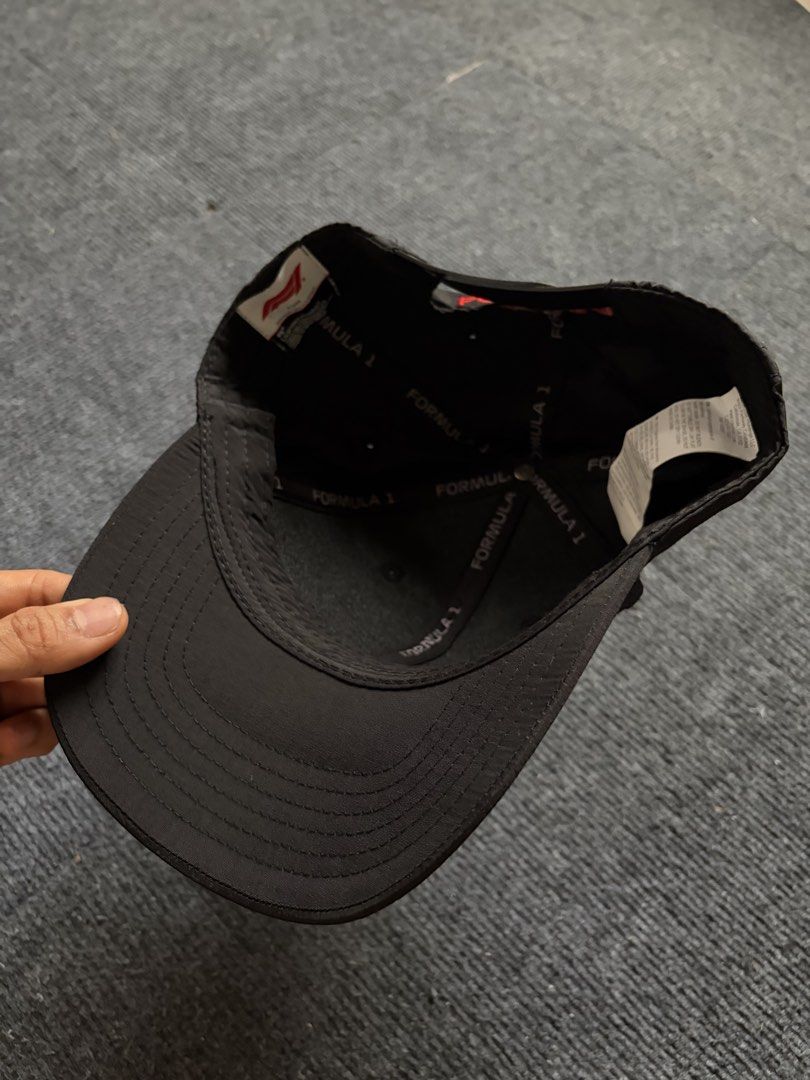 Formula 1 Black F1 Snapback Cap Hat (Category: Caps & Hats) located in Manila. Submitted by toys_hats005 (Listing ID 1467957118, Image 3). Description: - Official Formula 1 merchandise - Color: Classic black with striking red accents - Bold red rubberized F1 logo on the front - "FORMULA 1" embroidered in red on the back strap - Adjustable plastic snap closure for a custom fit - Lightweight, breathable material for all-day comfort - Branded interi
