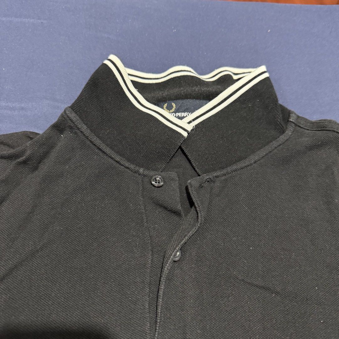 Fred Perry Black Polo Shirt (Category: Tshirts & Polo Shirts ) located in Quezon City. Submitted by mixpickz.qc (Listing ID 1468043662, Image 2). Description: - Brand: Fred Perry - Item: Slim Fit Polo Shirt - Color: Black - Size: L (Pit-to-pit: 21 inches, Length: 27 inches) - Details: Classic twin tipping on collar and cuffs, embroidered laurel wreath logo - Material: Breathable cotton piqué 9/10 color rate What you see is what you get.
