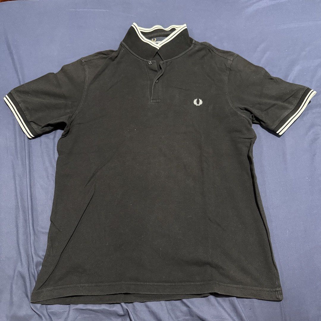 Fred Perry Black Polo Shirt (Category: Tshirts & Polo Shirts ) located in Quezon City. Submitted by mixpickz.qc (Listing ID 1468043662, Image 1). Description: - Brand: Fred Perry - Item: Slim Fit Polo Shirt - Color: Black - Size: L (Pit-to-pit: 21 inches, Length: 27 inches) - Details: Classic twin tipping on collar and cuffs, embroidered laurel wreath logo - Material: Breathable cotton piqué 9/10 color rate What you see is what you get.