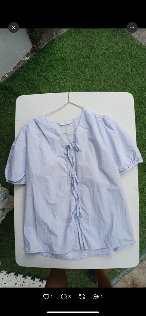 FU Light Blue Tie-Front Puff Sleeve Blouse (Category: Blouses) located in Alaminos. Submitted by amor1986 (Listing ID 1467862100, Image 1). Description: - Color: Light blue - Material: Lightweight, breathable cotton - Design: Short puff sleeves, V-neckline, and front tie closures - Fit: Loose and comfortable - Brand/Tag: Tagged FU at the collar - Styling: Great with denim shorts or skirts for warm days Small to Medium Frame Sinusuot ko nung Bunti