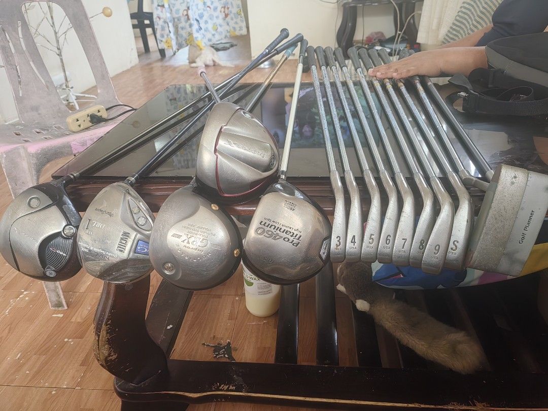 Full Golf Club Set Driver Irons Putter (Category: Golf) located in Silang. Submitted by jamessseller (Listing ID 1467872099, Image 2). Description: - Complete golf club set, ready for the course - Includes multiple drivers, irons (3 through 9), sand wedge, and a putter - Features various shaft designs and grips - Shows typical signs of previous play on heads and shafts - Great value set for beginners and regular players alike.