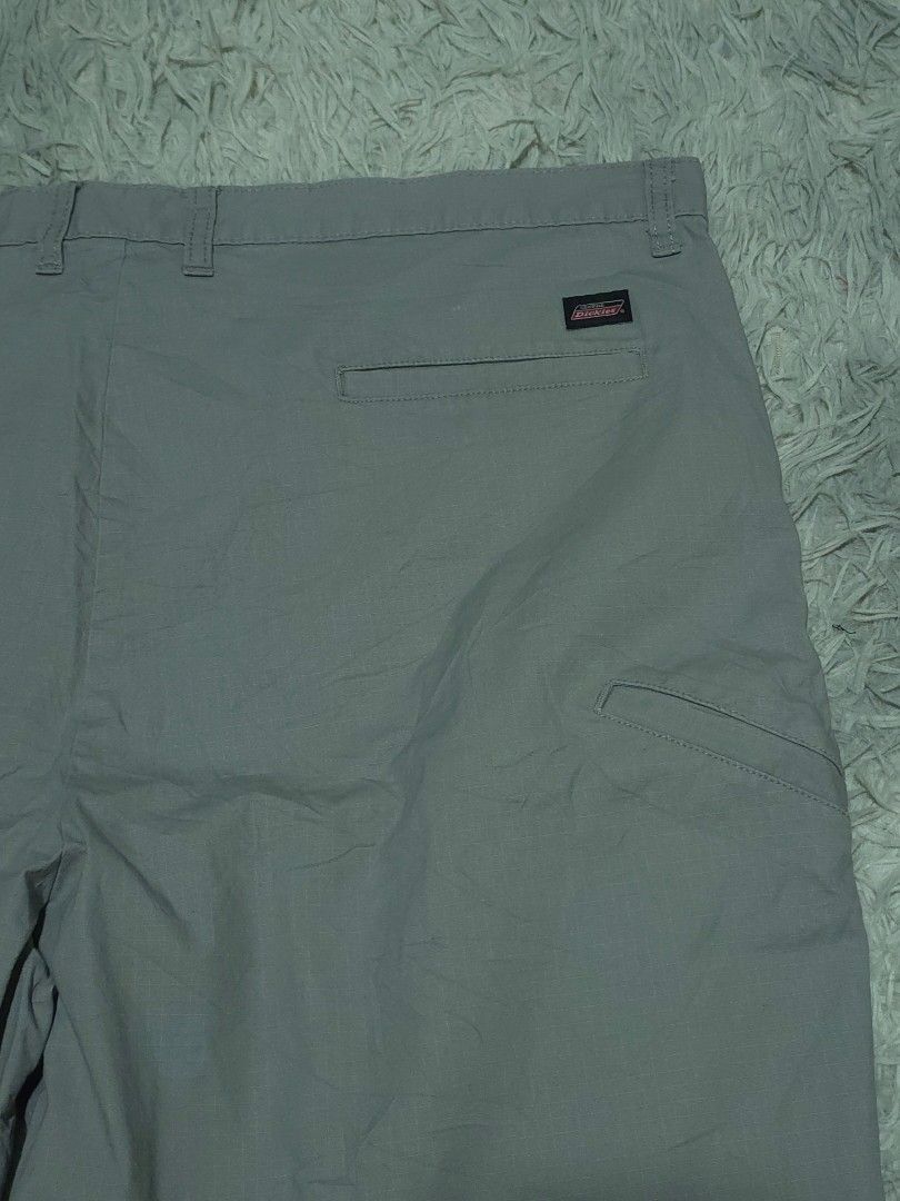Genuine Dickies Gray Cargo Shorts (Category: Shorts) located in Abulug. Submitted by humanwhosellthings (Listing ID 1467887670, Image 3). Description: - Brand:DICKIES Short ✅Excellent Condition ✅Issue: none ▫️Waist Size: 42 ▫️Length: 22 - Color: Gray - Style: Casual cargo shorts for daily wear - Material: Durable ripstop fabric - Details: Front button closure, waistband belt loops, back welt pockets - Branding: Iconic Dickies logo patch on the le