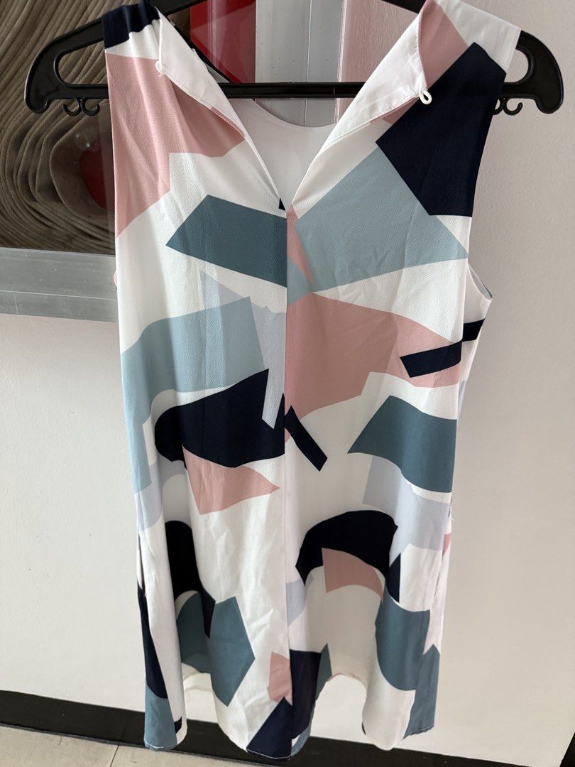 Geometric Print Sleeveless Dress (Category: Dresses) located in Mandaluyong City. Submitted by declutteringmylife101 (Listing ID 1467904953, Image 2). Description: - Design: Abstract geometric pattern in navy, pink, and teal on white - Style: Sleeveless with a versatile reversible neckline (scoop neck on one side, V-neck with collar detail on the other) - Fabric: Lightweight and smooth-lined for maximum comfort - Versatility: Perfect casual piece