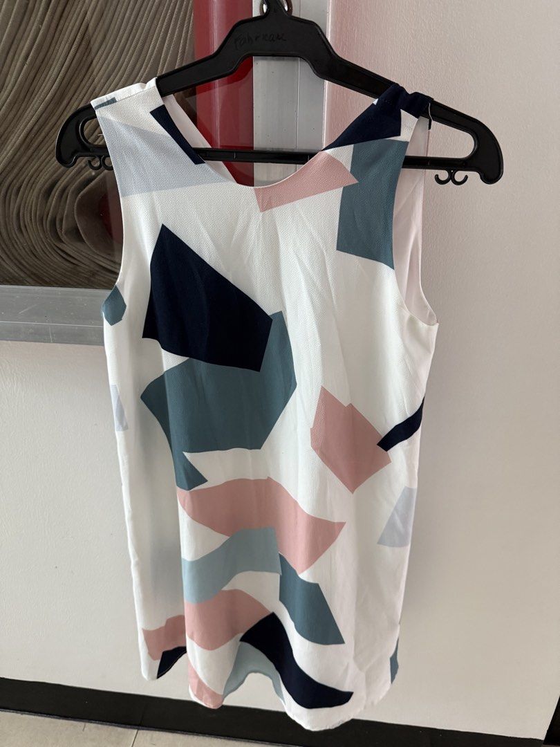Geometric Print Sleeveless Dress (Category: Dresses) located in Mandaluyong City. Submitted by declutteringmylife101 (Listing ID 1467904953, Image 1). Description: - Design: Abstract geometric pattern in navy, pink, and teal on white - Style: Sleeveless with a versatile reversible neckline (scoop neck on one side, V-neck with collar detail on the other) - Fabric: Lightweight and smooth-lined for maximum comfort - Versatility: Perfect casual piece