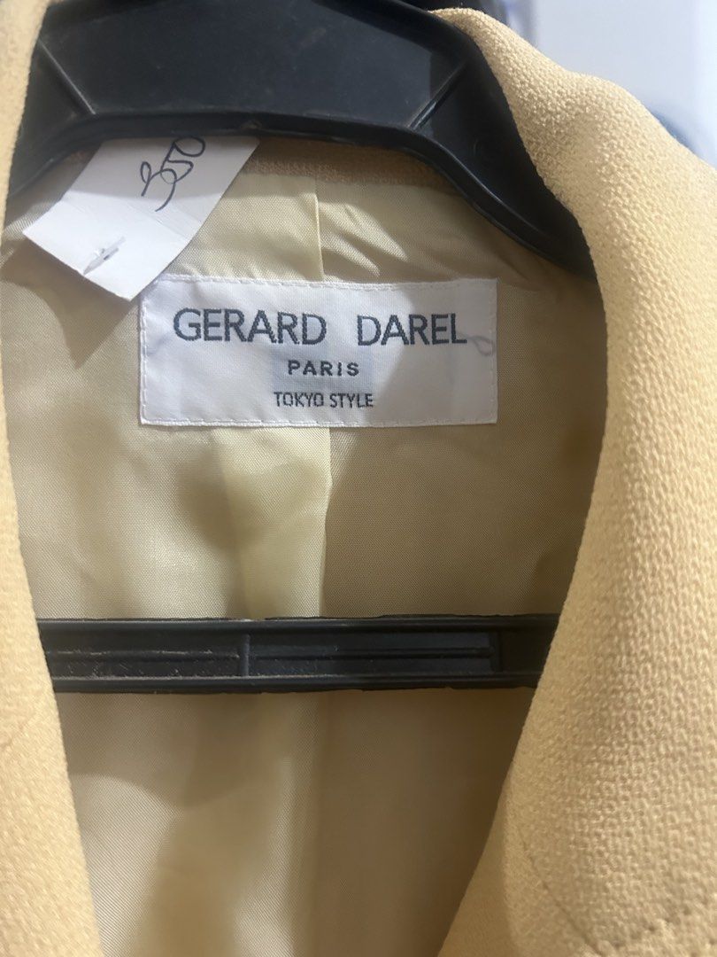 GERARD DAREL PARIS (Category: Coats, Jackets and Outerwear) located in Cavite. Submitted by cecitrifthshop (Listing ID 1467896954, Image 2). Description: This is a vintage pale yellow/beige tailored blazer by the French fashion house Gérard Darel Paris, featuring structured lapels, patch pockets, and ornate gold-tone buttons.
