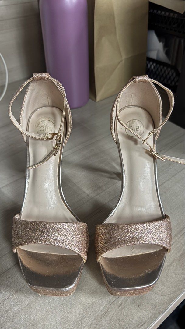 Gibi Rose Gold Glitter Platform Heels Size 35 (Category: Heels) located in Quezon City. Submitted by annaalexiscjoseph (Listing ID 1467872979, Image 1). Description: - Brand: Gibi - Color: Rose Gold with textured glitter pattern - Size: 35 (printed on insole) - Style: Open toe, platform sole with clear chunky acrylic heels - Closure: Ankle strap with adjustable buckle - Details: Neutral nude inner lining, stylish and party-ready.