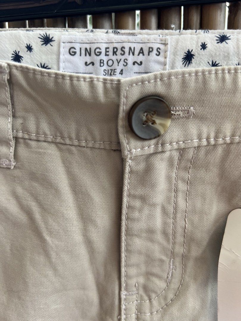 Gingersnaps Boys Khaki Pants Size 4 (Category: Babies & Kids Fashion) located in Taguig. Submitted by bestthriftxx (Listing ID 1467859410, Image 2). Description: - Brand: Gingersnaps - Size: Boys 4 - Color: Classic neutral beige/khaki - Features: Button closure, belt loops, and adorable star-patterned inner lining - Condition: Brand new with tag still attached to the front pocket.
