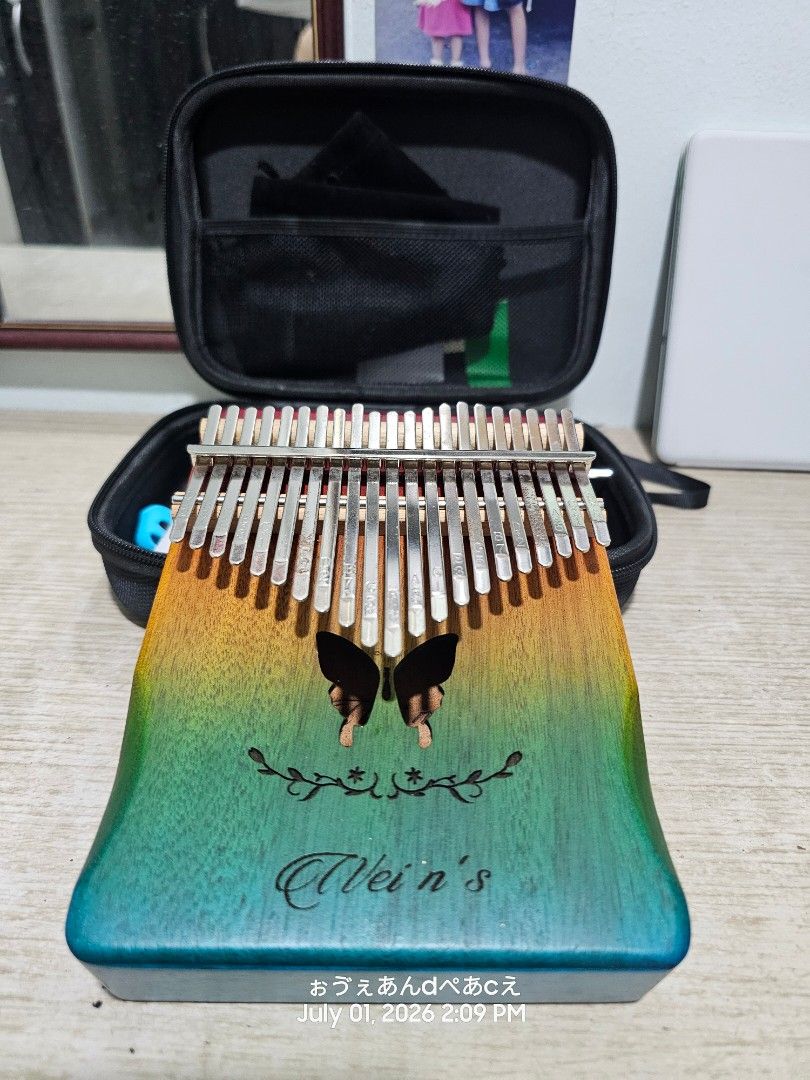 Gradient Wood Kalimba Thumb Piano with Hard Case (Category: Musical Instruments) located in Dasmarinas. Submitted by jazvielle (Listing ID 1467910661, Image 1). Description: - Instrument: 17-key wooden kalimba with pre-stamped notes and numbers - Design: Stunning blue-to-yellow gradient finish with delicate butterfly and floral laser engravings - Beginner-Friendly: Easy to pick up and play melodies quickly - Included Accessories: Black zipped har