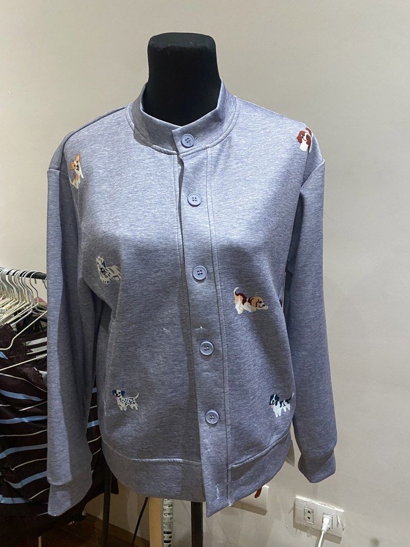 Grey Dog Print Button Up Cardigan Sweatshirt (Category: Longsleeves) located in Manila. Submitted by mpt99876 (Listing ID 1467992565, Image 1). Description: - Color & Style: Grey heather knit cardigan with a relaxed fit and mock neck - Design: Cute all-over dog embroidery with matching light blue buttons - Material: Soft and cozy sweatshirt fabric - Features: Long sleeves, button-front closure, ribbed hem and cuffs - Perfect for: Dog lovers and e