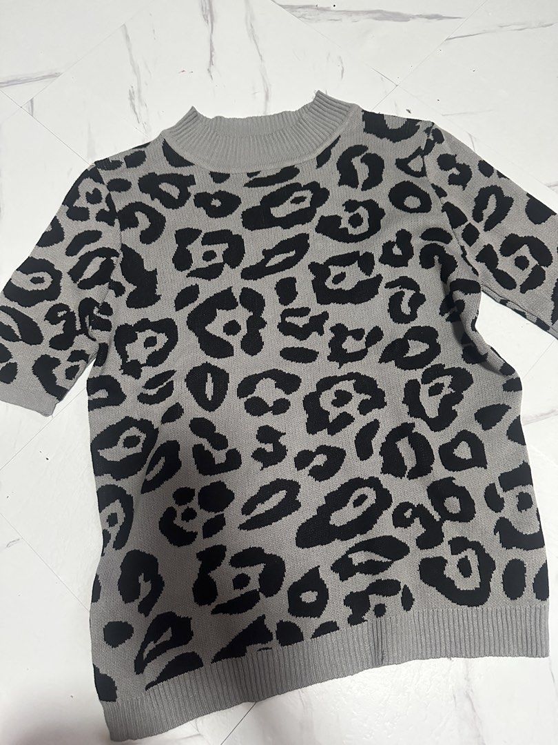 Grey Leopard Print Knit cotton (Category: Longsleeves) located in Manila. Submitted by tipidfinds888 (Listing ID 1468028260, Image 1). Description: - Style: Grey knit sweater with an all-over black leopard print - Design: Short sleeves with ribbed collar, cuffs, and hem - Material: Soft and comfortable knit fabric - Versatility: Easy to pair with jeans or skirts for a casual daily look - Condition: Brand new / Excellent quality.