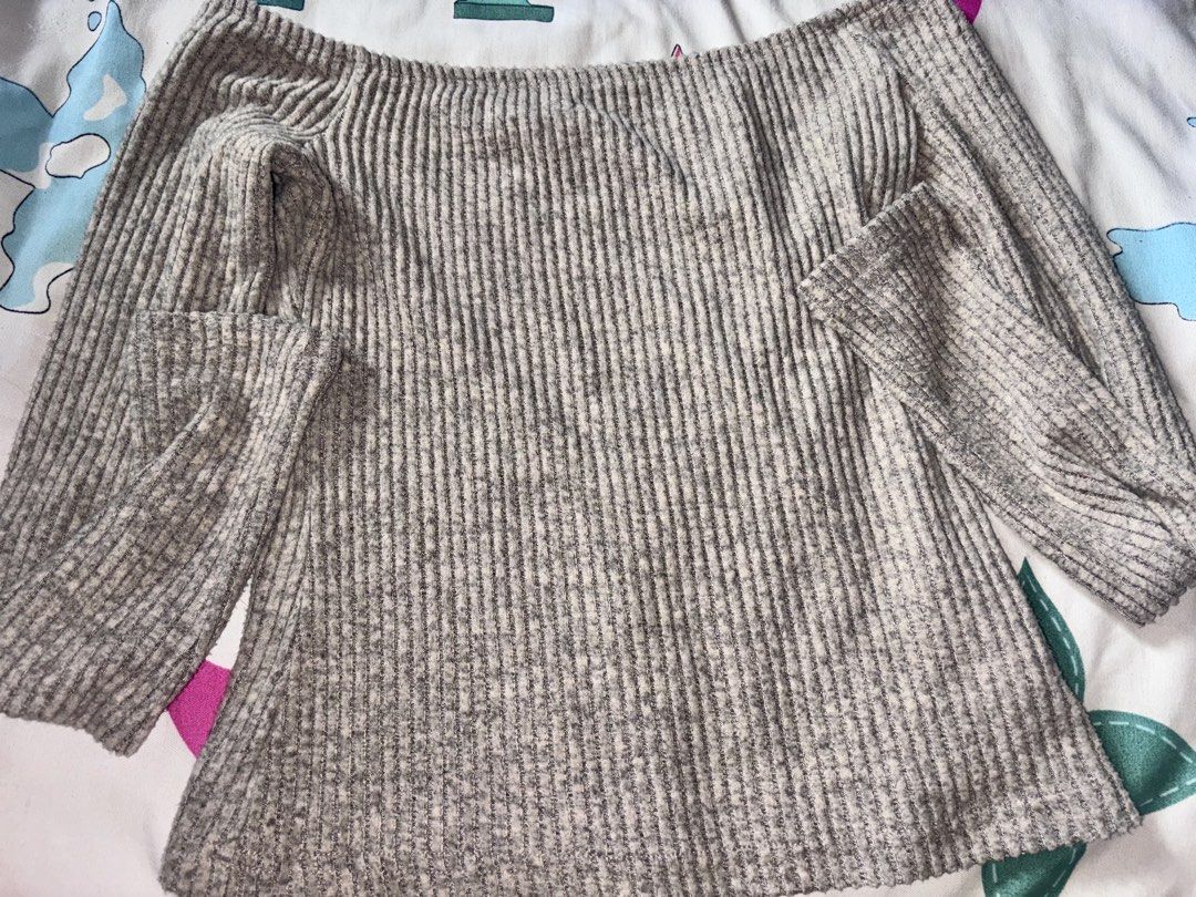 Grey Off-Shoulder Ribbed Knit Sweater (Category: Longsleeves) located in Bacoor. Submitted by fmax19 (Listing ID 1467899418, Image 2). Description: - Style: Off-shoulder ribbed knit sweater - Color: Grey - Size: XS - Details: Long sleeves, soft textured fabric with vertical stripes .
