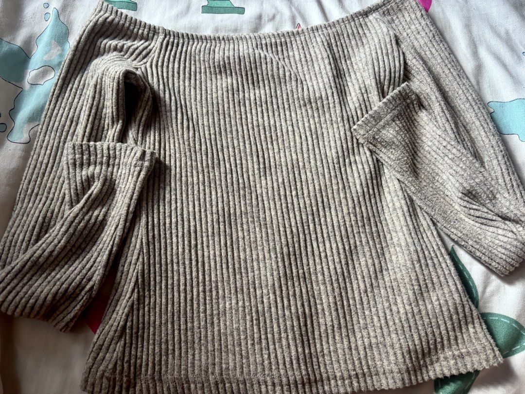 Grey Off-Shoulder Ribbed Knit Sweater (Category: Longsleeves) located in Bacoor. Submitted by fmax19 (Listing ID 1467899418, Image 1). Description: - Style: Off-shoulder ribbed knit sweater - Color: Grey - Size: XS - Details: Long sleeves, soft textured fabric with vertical stripes .