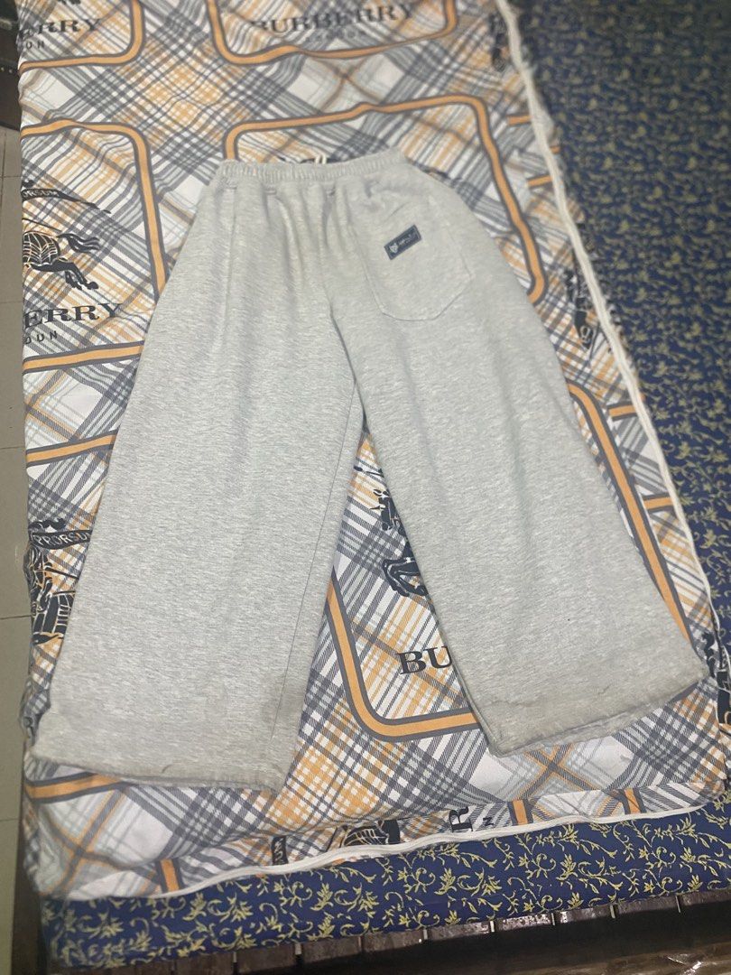 Grey Sweatpants Joggers with Drawstring and Back Pocket (Category: Joggers) located in Manila. Submitted by sonder777.329 (Listing ID 1467991617, Image 2). Description: Grey sweatpants, super comfy material. Elastic waistband with a drawstring. Back pocket with a small tag attached. Small stain spot on the front leg. Tiny holes near the bottom hem area. Great casual lounge pants for everyday chilling at home or running errands..