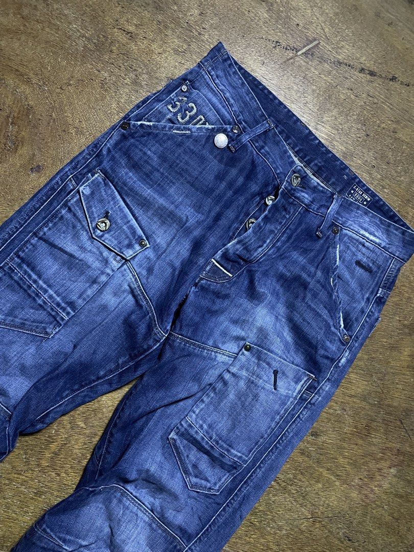 G-Star Raw 3301 Cargo Denim Jeans (Category: Jeans) located in Molave. Submitted by charlesthrifter (Listing ID 1467884296, Image 3). Description: - Brand: G-Star Raw 3301 - Type: Blue denim cargo jeans - Size: 30" waist / 34" length - Closure: Button fly - Pockets: Multiple cargo pockets on legs and back - Details: Articulated knee panels and distressed wash - Origin: Made in India - Style: Heavy utilitarian streetwear piece 34-35.