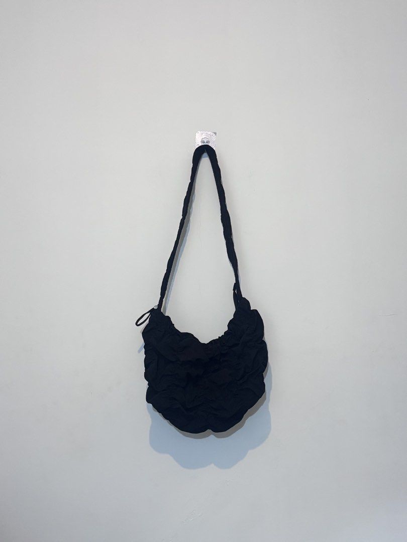 GU Black Ruched Shoulder Bag (Category: Shoulder Bags) located in Bulacan. Submitted by janeeeeelleeeee (Listing ID 1468001850, Image 1). Description: - Color: Black - Material: Soft, lightweight fabric - Design: All-over gathered texture with a minimalist style - Strap: Long, comfortable braided shoulder strap - Condition: Clean inside and out, ready to use - Perfect for daily casual wear and easy to match with different outfits.