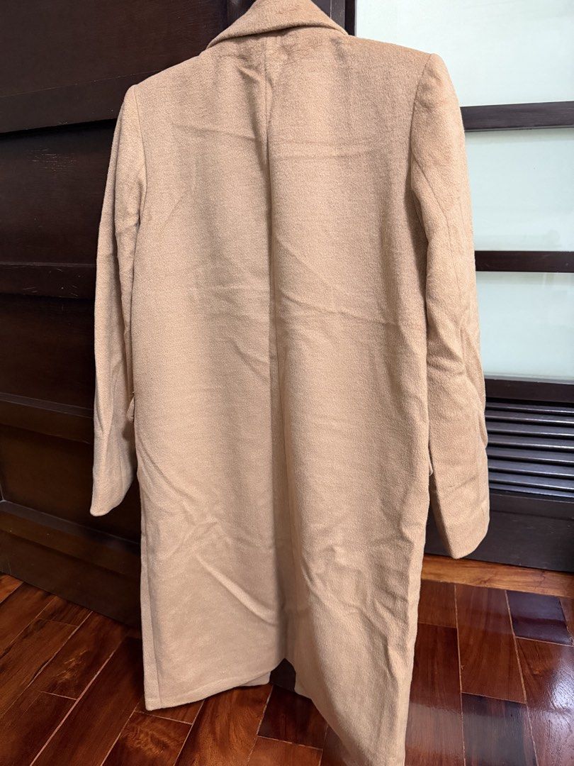 GU Camel Long Trench Wool Blend Coat Size S (Category: Coats, Jackets and Outerwear) located in Marikina City. Submitted by lucassantiano (Listing ID 1467864638, Image 3). Description: - Brand: GU - Style: Camel long coat - Size: S - Material: 67% polyester, 33% wool (fully lined with polyester) - Features: Front button closure, two front pockets - Condition: Clean overall, great warm layer for cold weather.