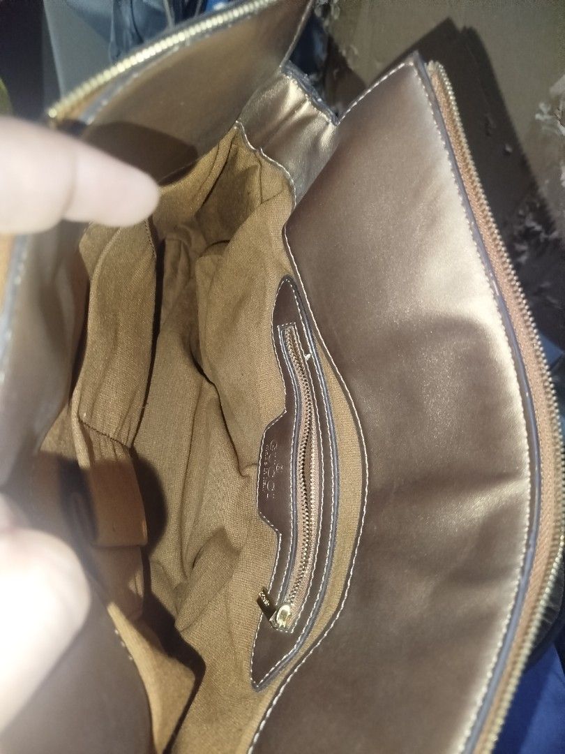 Gucci GG Monogram Metallic Gold Handbag (Category: Luxury Bags & Wallets) located in Manila. Submitted by alenoid (Listing ID 1467951825, Image 3). Description: - Gucci shoulder bag in classic GG monogram canvas - Elegant metallic gold leather handles and trim with chic side ribbon accents - Secure zip top closure - Roomy interior featuring a zippered pocket and official Gucci 'Made in Italy' hardware plate - Ideal everyday luxury bag for work or