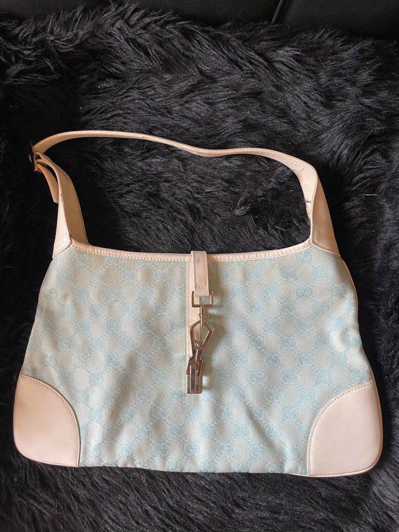Gucci Jackie Monogram Shoulder Bag (Category: Luxury Bags & Wallets) located in Davao. Submitted by boodle4lyf (Listing ID 1467922723, Image 1). Description: Authentic Gucci Jackie shoulder bag in rare light blue and cream GG monogram canvas with white leather trim. Features classic silver hardware and adjustable strap. Condition is very good but the main concern is the tiny spot stains at the back. Stains are removable. .