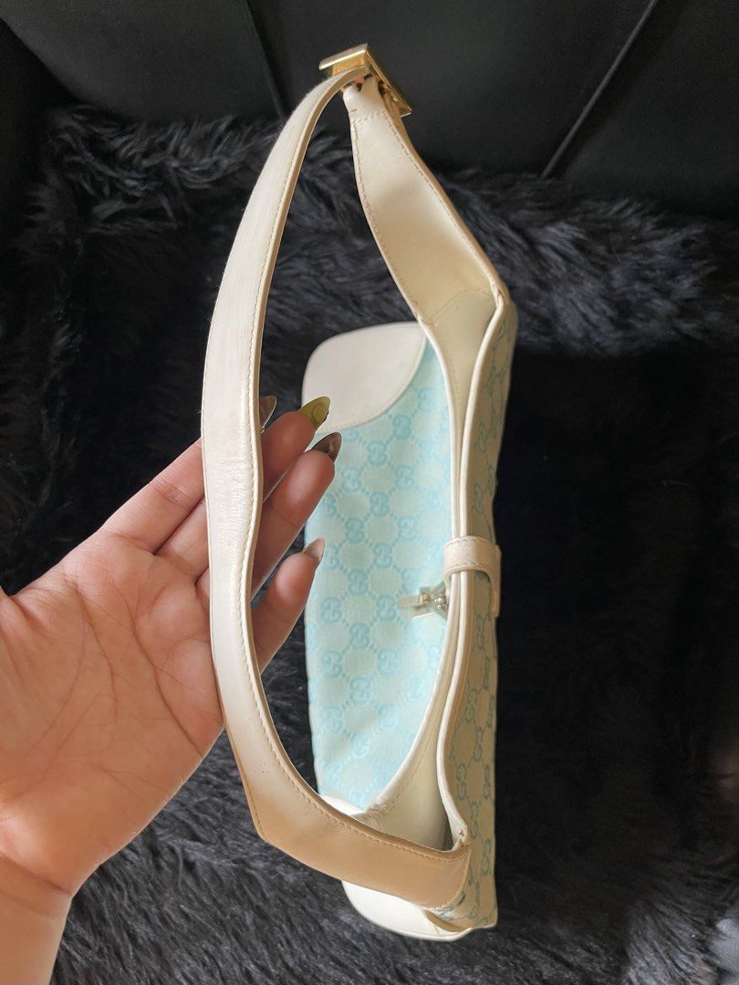 Gucci Jackie Monogram Shoulder Bag (Category: Luxury Bags & Wallets) located in Davao. Submitted by boodle4lyf (Listing ID 1467922723, Image 2). Description: Authentic Gucci Jackie shoulder bag in rare light blue and cream GG monogram canvas with white leather trim. Features classic silver hardware and adjustable strap. Condition is very good but the main concern is the tiny spot stains at the back. Stains are removable. .