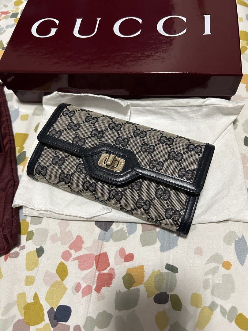 Gucci Luce Long Wallet (Category: Luxury Bags & Wallets) located in Batangas. Submitted by ksonaco (Listing ID 1467943400, Image 2). Description: Gucci Luce Long Wallet (Style 790034) 2024 - beige and blue GG canvas, dark blue leather trim, and a gold-toned twist turn-lock fastening. - Long wallet with front flap and gold-tone lock closure - Classic monogram canvas with dark leather trim - Multiple card slots and a secure zipped compartment - Cle