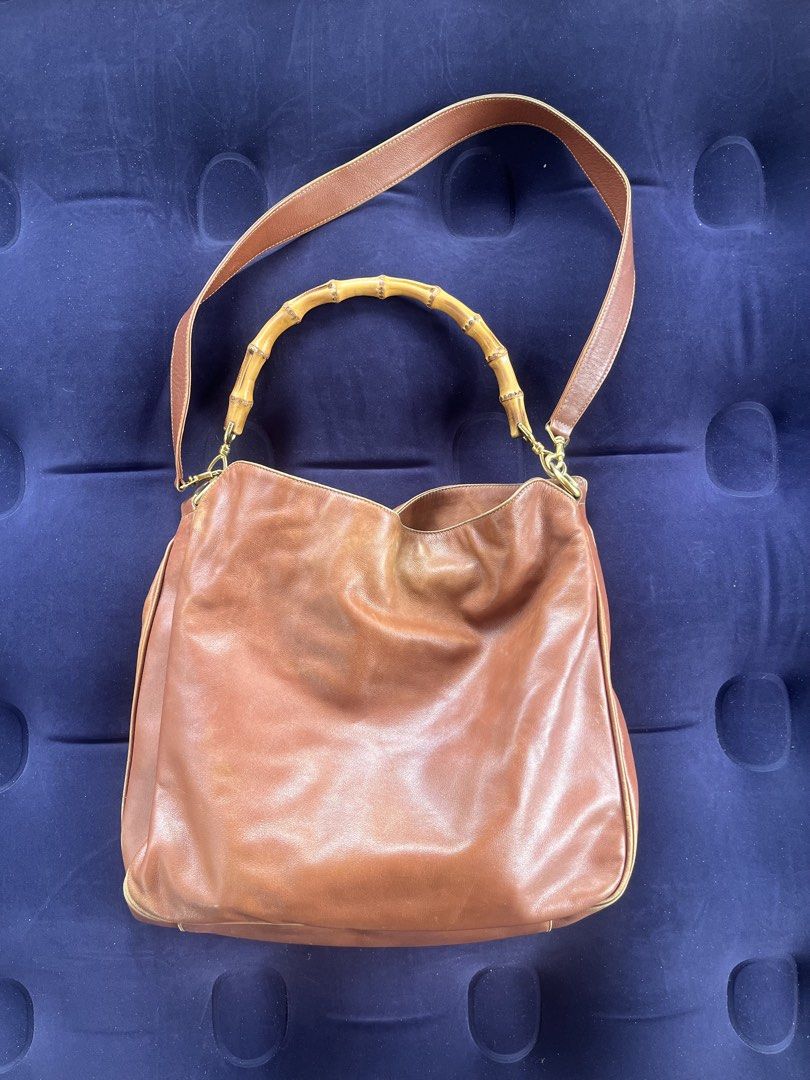 Gucci tom ford vintage bamboo two way (Category: Shoulder Bags) located in Tacloban City. Submitted by luxbag_phhh (Listing ID 1467848191, Image 1). Description: Authentic tom ford era gucci brown leather shoulder bag featuring a distinctive bamboo top handle and brass hardware. Includes a matching long leather strap for versatile wear. Soft slouchy structure with gold piping accents along the edges. Great everyday size with plenty of room inside