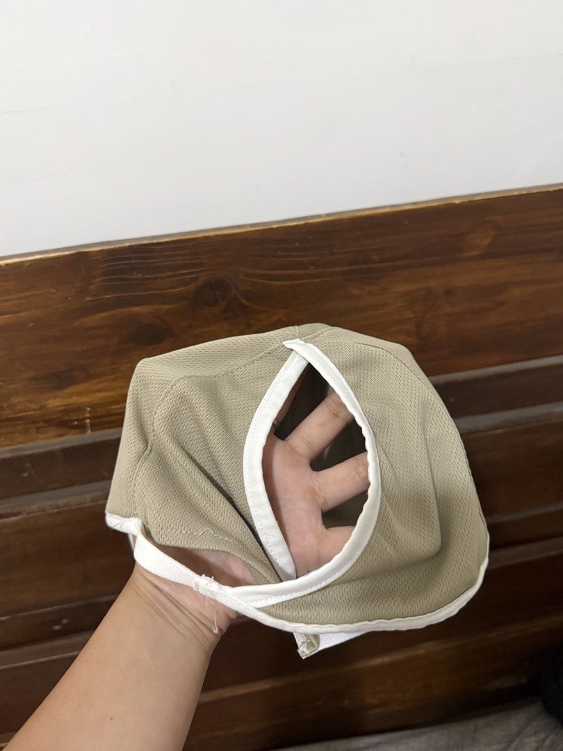 Gymshark Beige Running Cap (Category: Activewear) located in Caloocan City. Submitted by bellita_05 (Listing ID 1468023714, Image 2). Description: - Brand: Gymshark - Color: Khaki beige with white trim along the brim - Features: Ponytail hole cut out for workouts, super lightweight mesh fabric - Branding: Gymshark logo printed on the front - Fit: One size fits all with an adjustable strap - Condition: Inner wash tag intact.