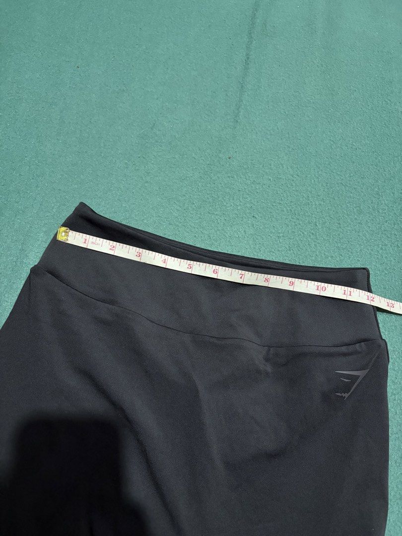 Gymshark Black Leggings (Category: Activewear) located in Guihulngan. Submitted by fbthriftgoodsniace (Listing ID 1467916076, Image 3). Description: Gymshark black leggings with the classic logo stamped near the waistband. High-waisted design, great stretch for workouts or lounging. Total length measures around 35.5 inches, waist flat lay is about 13 inches across. Super soft, breathable fabric. No flaws, clean and ready to wear..