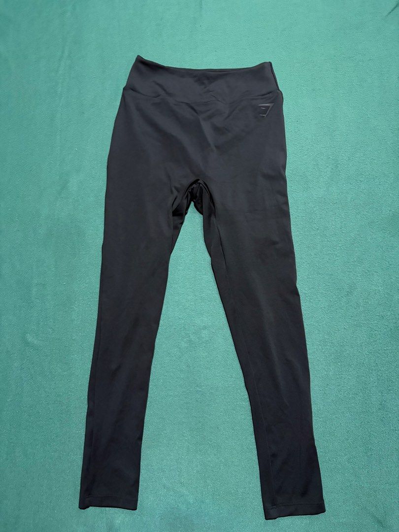 Gymshark Black Leggings (Category: Activewear) located in Guihulngan. Submitted by fbthriftgoodsniace (Listing ID 1467916076, Image 1). Description: Gymshark black leggings with the classic logo stamped near the waistband. High-waisted design, great stretch for workouts or lounging. Total length measures around 35.5 inches, waist flat lay is about 13 inches across. Super soft, breathable fabric. No flaws, clean and ready to wear..