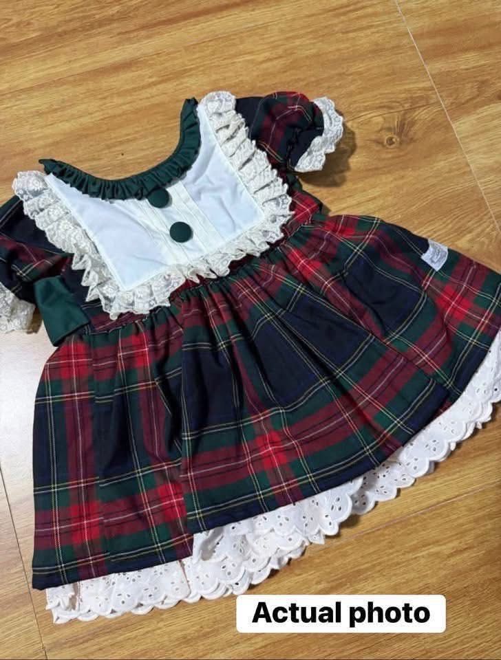 Hailey Christmas dress S2 (Category: Babies & Kids Fashion) located in Taguig. Submitted by aj030 (Listing ID 1467965611, Image 2). Description: - Festive tartan plaid holiday dress in classic red, green, and black - Adorable white bib collar with delicate white lace edging - Cute short puff sleeves and ruffled dark green neckline with buttons - Charming layered white eyelet lace hem - Perfect holiday outfit for toddlers -Size medium Can fit 1-3 