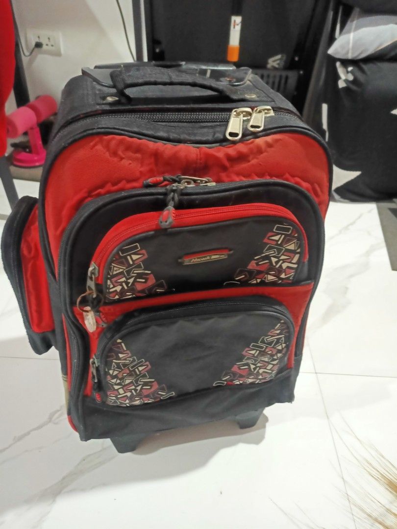 Hawk Rolling Backpack Black and Red Wheeled Bag (Category: Strollers) located in Manila. Submitted by pham012 (Listing ID 1467869029, Image 1). Description: - Brand/Model: Hawk Rolling Backpack - Color: Black and red with a stylish geometric triangle pattern ori - Storage: Multiple zippered - Use: Durable and perfect for school - Condition: Normal signs of use visible on the fabric -Original HAWK -naglagay ako ng freebies inside.
