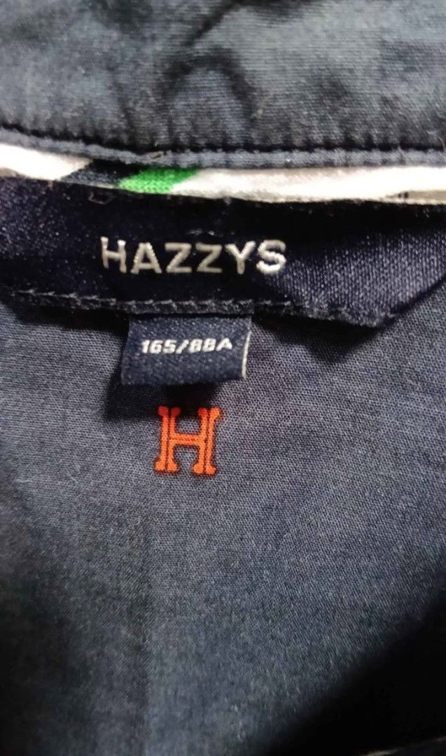 Hazzys Navy Blue Button Down Dress (Category: Dresses) located in Cebu City. Submitted by mcmapio (Listing ID 1467966782, Image 2). Description: - Brand: Hazzys - Color: Navy blue with cute embroidered crowns, dogs, and red H logos - Style: Short-sleeve shirt dress, button-down front, collared neckline, and pleated skirt - Size: 165/88A - Material: Lightweight, breathable cotton - Versatile: Great for daily wear, office outfits, or weekend lakad 