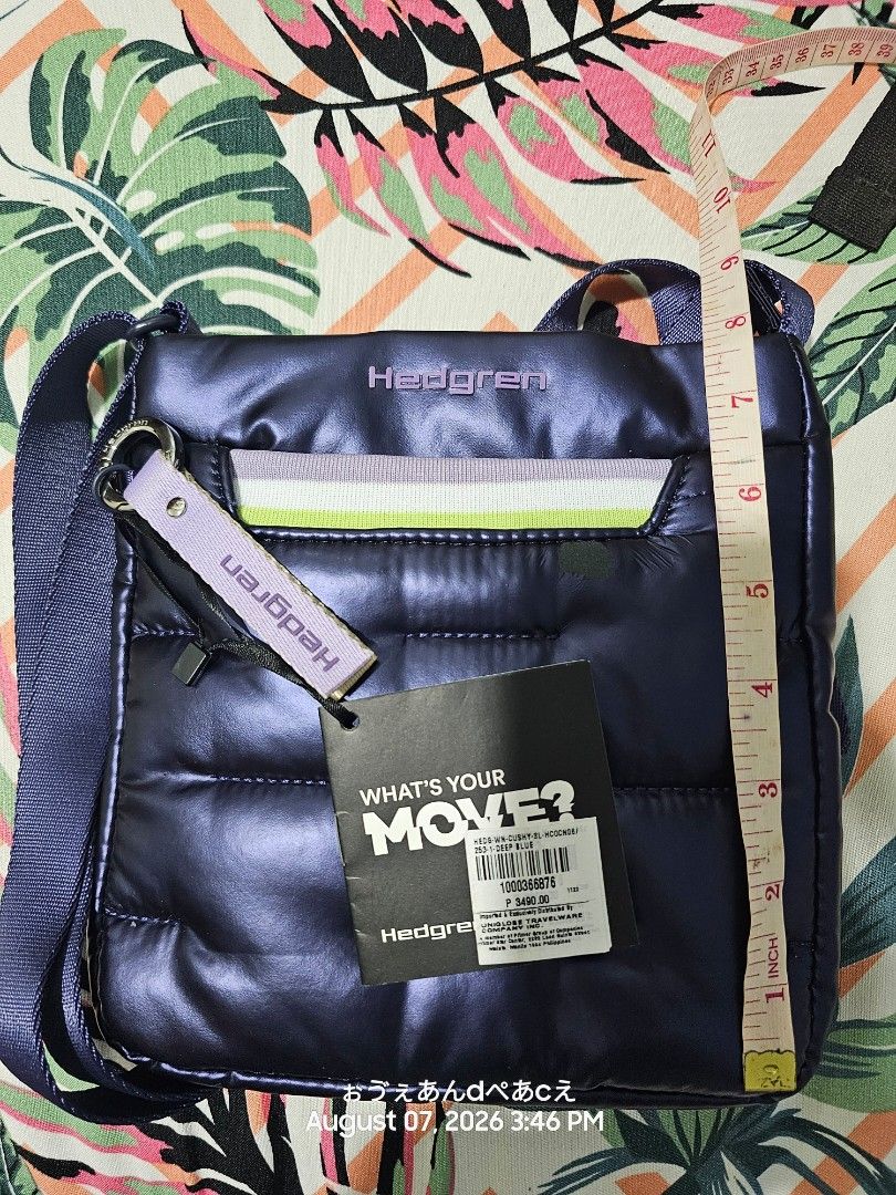 Hedgren Cushy Deep Blue Crossbody Bag (Category: Shoulder Bags) located in Dasmarinas. Submitted by jazvielle (Listing ID 1467934656, Image 3). Description: - Brand: Hedgren Puffy Crossbody Bag - Color: Deep Blue - Condition: Brand new with tag attached (Original retail price: PHP 3,490) - Inclusion: Trendy branded ribbon strap accessory on the front ring - Flaw Alert: Small green patch defect on the upper right front pocket (circled in photos) -