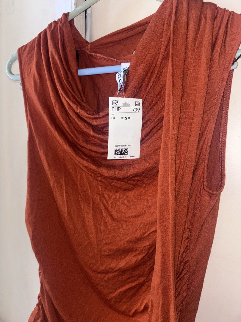 H&M Rust Red Cowl Neck Sleeveless Top (Category: Sleeveless) located in Bacoor. Submitted by fmax19 (Listing ID 1467892263, Image 3). Description: - Brand: H&M - Color: Rust Red - Size: S (tag) - Condition: Brand new, never worn with original PHP 799 store tag attached - Material: Soft and stretchy fabric - Details: Draped cowl neckline and flattering gathered side details.