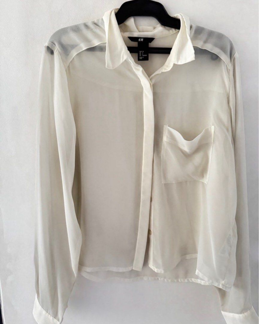 H&M Sheer Button-Down Blouse Off-White (Category: Blouses) located in Bulacan. Submitted by _arislmt (Listing ID 1467866041, Image 1). Description: - Brand: H&M - Color: Off-white - Material: Lightweight, translucent sheer fabric - Features: Pointed collar, front button placket, single chest pocket on the right side - Sleeves: Long sleeves with button cuffs - Style: Great layering piece for versatile outfits - Condition: Excellent.