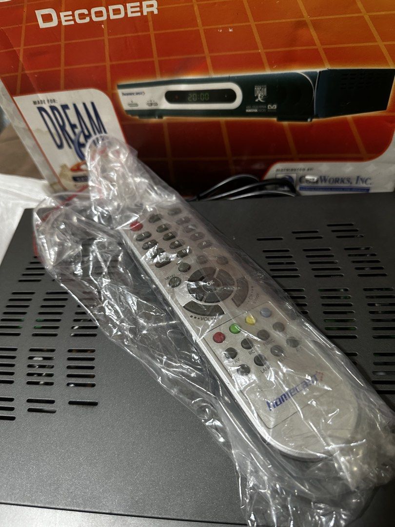 Homecast Satellite TV Decoder with Remote Control (Category: TV Parts & Accessories) located in Manila. Submitted by macky2026 (Listing ID 1467947152, Image 3). Description: Vintage Dream Satellite TV Decoder (Homecast eM-152USNA) - Collectible / Prop Price: 500.00 CONDITION: Open original retail box with decoder unit and remote control. This is a vintage Homecast Satellite TV Decoder manufactured for the legacy Dream Satellite TV broadcasting ne