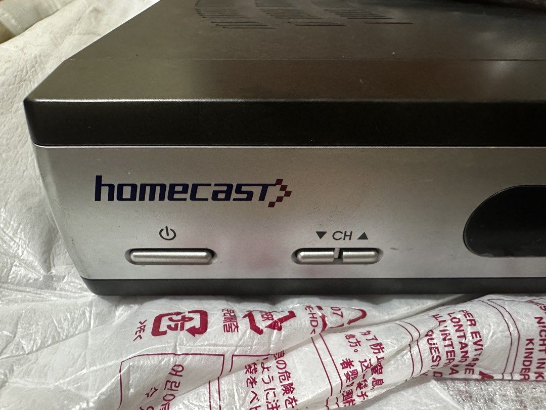 Homecast Satellite TV Decoder with Remote Control (Category: TV Parts & Accessories) located in Manila. Submitted by macky2026 (Listing ID 1467947152, Image 2). Description: Vintage Dream Satellite TV Decoder (Homecast eM-152USNA) - Collectible / Prop Price: 500.00 CONDITION: Open original retail box with decoder unit and remote control. This is a vintage Homecast Satellite TV Decoder manufactured for the legacy Dream Satellite TV broadcasting ne
