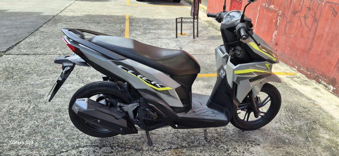 Honda Click 125i Scooter (Category: Motorbikes for Sale) located in Manila. Submitted by muimui722 (Listing ID 1467920772, Image 3). Description: Honda Click scooter in grey with yellow accents. Odometer reads 43,972 kilometers. Digital dashboard panel and key ignition. Clean body panels and standard black seat. Stock exhaust pipe and alloy wheels equipped. Tires have decent tread depth remaining. Engine starts up fine. Registered documents ready