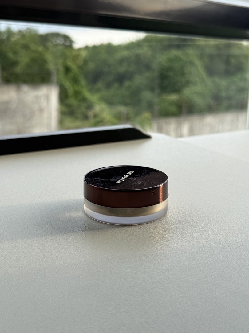 Hourglass Veil Translucent Setting Powder Mini (Category: Makeup) located in Manila. Submitted by diyeena2993230 (Listing ID 1468016471, Image 2). Description: Hourglass Veil Translucent Setting Powder, mini size 2g. Travel friendly jar with black screw cap and gold branding. Bottom label shows shade and manufacturing details. Minor scuffs on lid exterior. Powder inside untouched and unused. Great for touch ups on the go or testing out the formul
