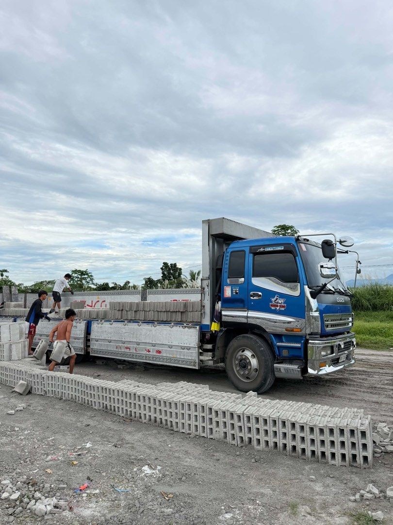 Isuzu flatbed cargo truck with concrete blocks (Category: Construction & Building Materials) located in Manila. Submitted by 46c93c6736a3b5812c36e6e9bcc5b6 (Listing ID 1467844826, Image 1). Description: - Reliable blue Isuzu heavy-duty flatbed truck - Sturdy open cargo bed setup ideal for commercial transport - Built for heavy construction work and hauling materials - Perfect for moving concrete hollow blocks and supplies - Ready for work and dep