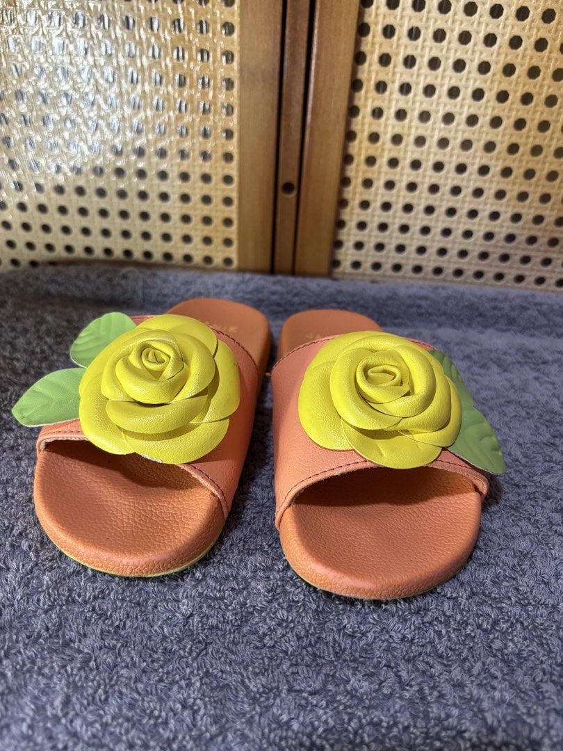 Janie and Jack Yellow Rose Sandals (Category: Babies & Kids Fashion) located in Manila. Submitted by wardrobeinmnl (Listing ID 1467893400, Image 2). Description: - Brand: Janie and Jack (Swim Line) - Size: 9 - Color/Design: Pink slides with 3D yellow rose and green leaves - Features: Textured footbeds and non-slip soles - Condition: Good, with minor sticker residue underneath soles - Origin: Made in China.
